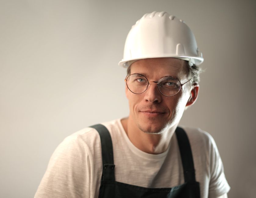Smiling window installation contractor reviewing project plans